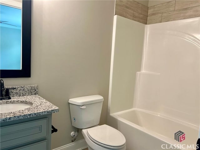 full bath with baseboards, toilet, shower / washtub combination, and vanity