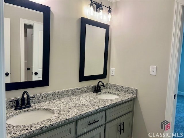 bathroom featuring double vanity and a sink