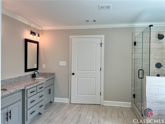 full bath featuring visible vents, a shower stall, and crown molding