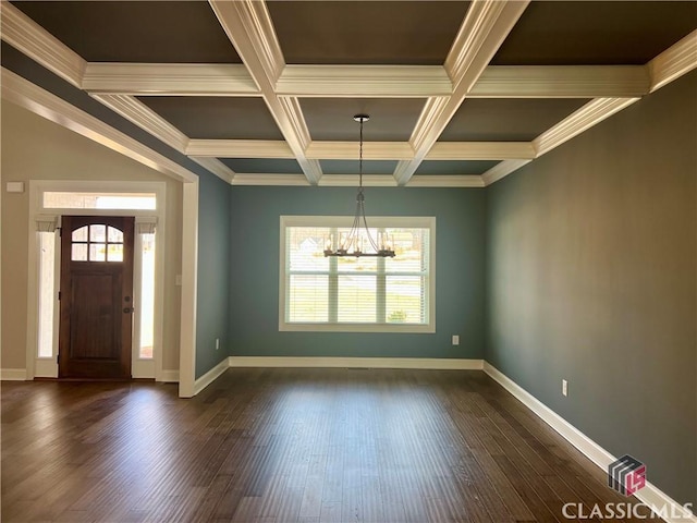 foyer featuring dark wood finished floors, an inviting chandelier, and a wealth of natural light