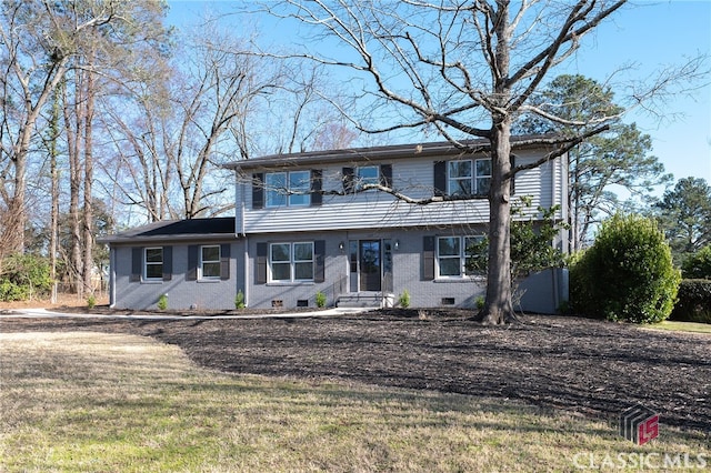 colonial inspired home with a front lawn