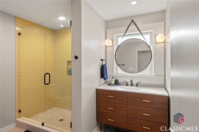 bathroom featuring recessed lighting, vanity, and a shower stall