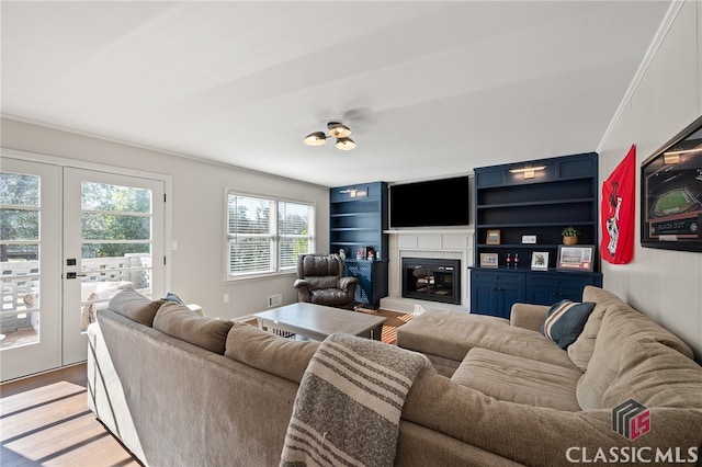 living room featuring a glass covered fireplace