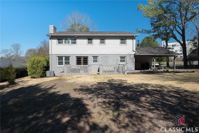 back of property featuring central AC unit and a chimney