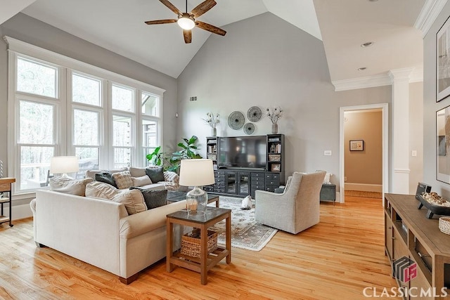 living area with high vaulted ceiling, crown molding, a ceiling fan, and light wood finished floors