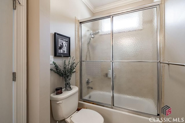 bathroom featuring enclosed tub / shower combo, toilet, and crown molding