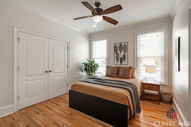 bedroom featuring crown molding, light wood-style flooring, and baseboards