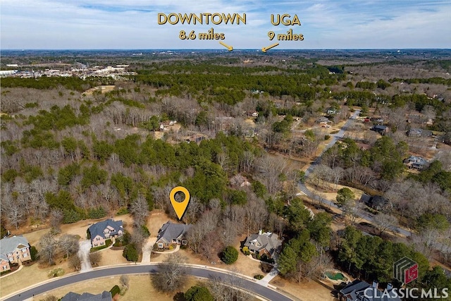 birds eye view of property with a wooded view