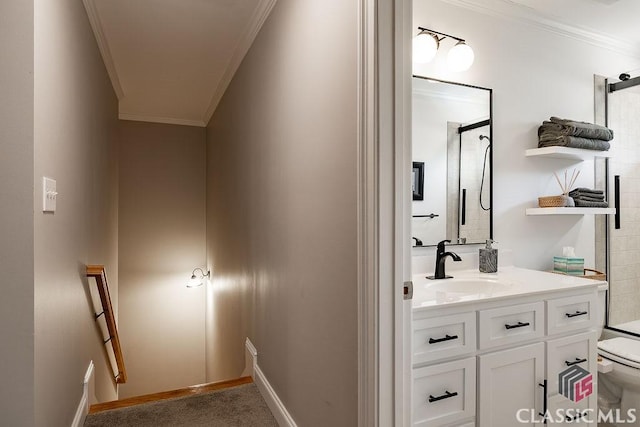 bathroom with vanity, toilet, a shower, and ornamental molding