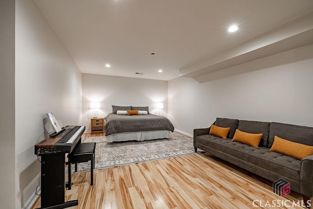 bedroom with visible vents, recessed lighting, wood finished floors, and baseboards