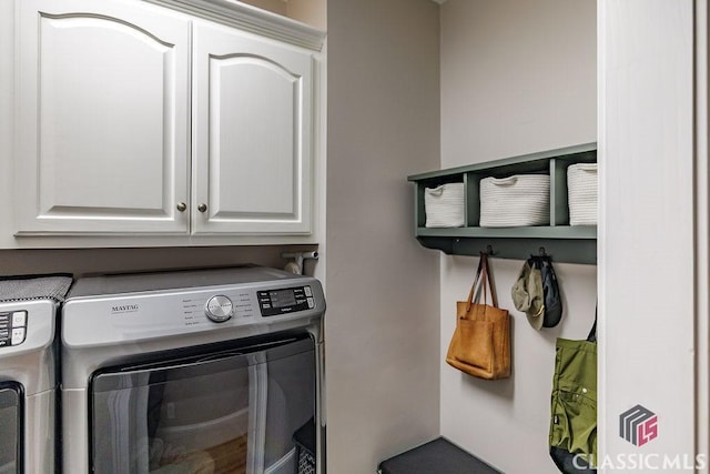 washroom with washer and dryer and cabinet space