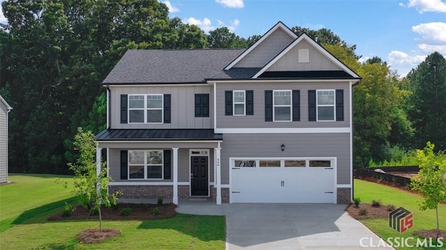 craftsman house featuring board and batten siding, a shingled roof, a front lawn, a garage, and driveway
