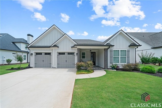 view of front of property with a garage, a front lawn, board and batten siding, and driveway