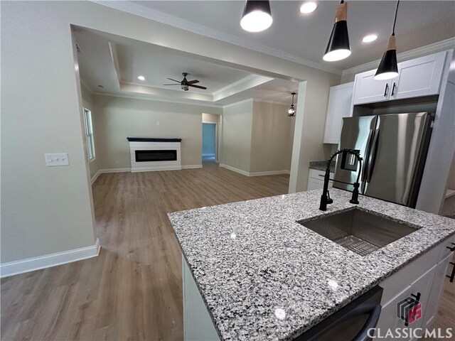 2850 Caboose Ct, Greensboro, GA 30642 - kitchen featuring crown molding, a sink, light wood-style flooring, a ceiling fan, and stainless steel refrigerator with ice dispenser