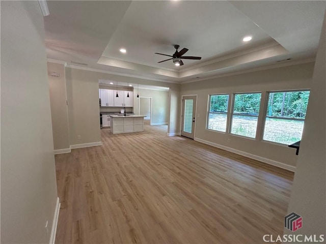 2850 Caboose Ct, Greensboro, GA 30642 - unfurnished living room featuring a ceiling fan, baseboards, ornamental molding, and a raised ceiling