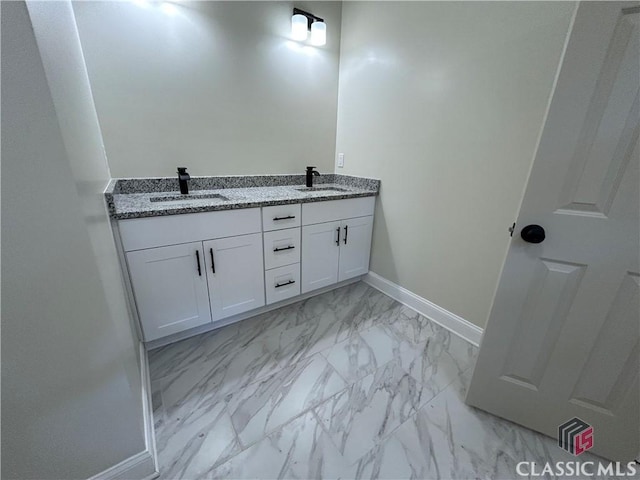 2850 Caboose Ct, Greensboro, GA 30642 - bathroom with a sink, baseboards, double vanity, and marble finish floor