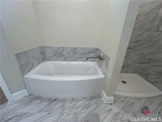 2850 Caboose Ct, Greensboro, GA 30642 - bathroom featuring baseboards, a stall shower, marble finish floor, and a garden tub