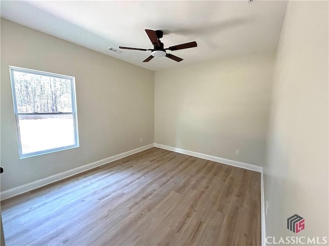 2850 Caboose Ct, Greensboro, GA 30642 - empty room with baseboards, a ceiling fan, wood finished floors, and visible vents