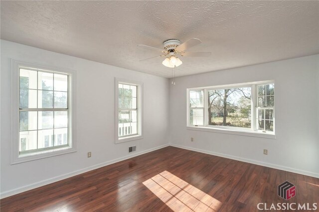 1050 Eugene Ln, Madison, GA 30650 - empty room with dark wood finished floors, baseboards, visible vents, and a ceiling fan