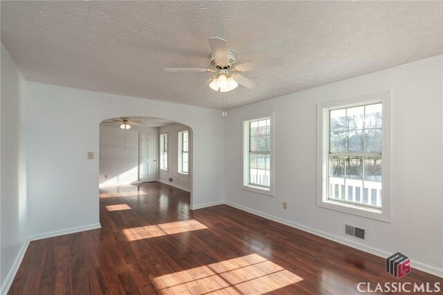 1050 Eugene Ln, Madison, GA 30650 - spare room with baseboards, arched walkways, visible vents, a ceiling fan, and wood finished floors