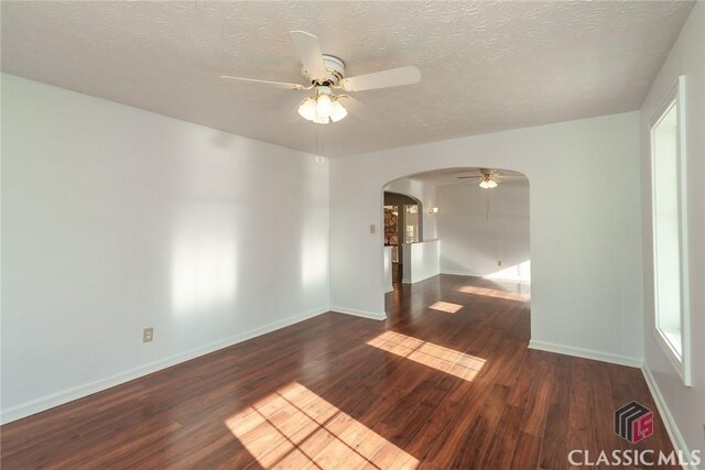 1050 Eugene Ln, Madison, GA 30650 - unfurnished room with baseboards, wood finished floors, arched walkways, and ceiling fan