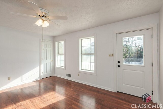 1050 Eugene Ln, Madison, GA 30650 - foyer entrance with a textured ceiling, visible vents, baseboards, a ceiling fan, and dark wood-type flooring
