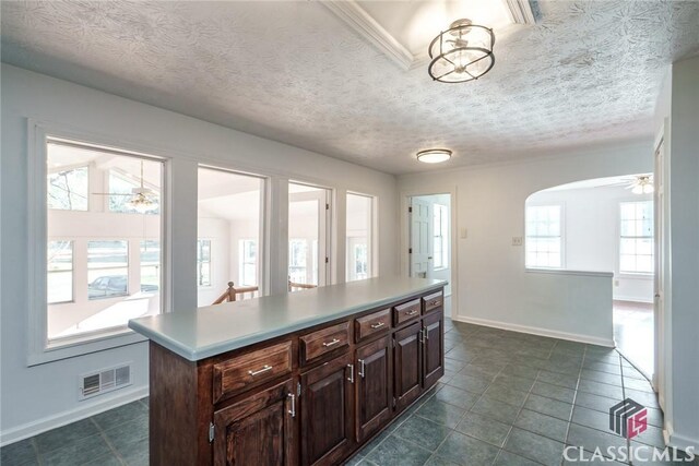 1050 Eugene Ln, Madison, GA 30650 - kitchen featuring plenty of natural light, visible vents, light countertops, and arched walkways