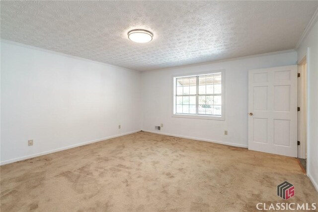 1050 Eugene Ln, Madison, GA 30650 - spare room featuring baseboards, crown molding, carpet floors, and a textured ceiling