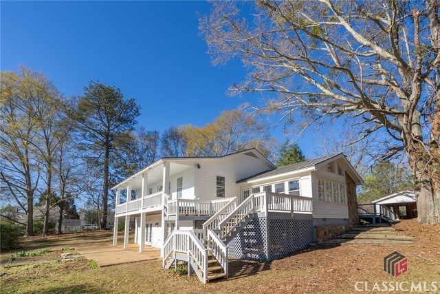 1050 Eugene Ln, Madison, GA 30650 - back of house featuring a wooden deck, crawl space, stairs, and metal roof