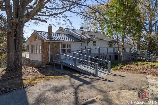 1050 Eugene Ln, Madison, GA 30650 - back of house featuring a standing seam roof, a chimney, a deck, metal roof, and crawl space