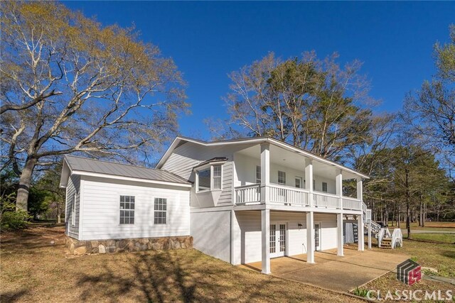 1050 Eugene Ln, Madison, GA 30650 - view of front of property featuring stairs, metal roof, a front yard, and french doors