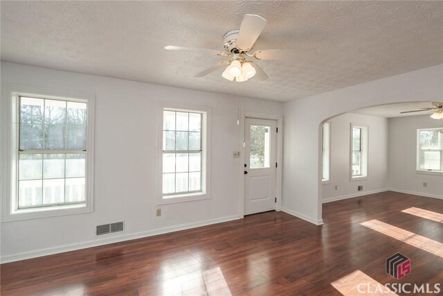 1050 Eugene Ln, Madison, GA 30650 - foyer featuring a textured ceiling, visible vents, wood finished floors, a ceiling fan, and arched walkways