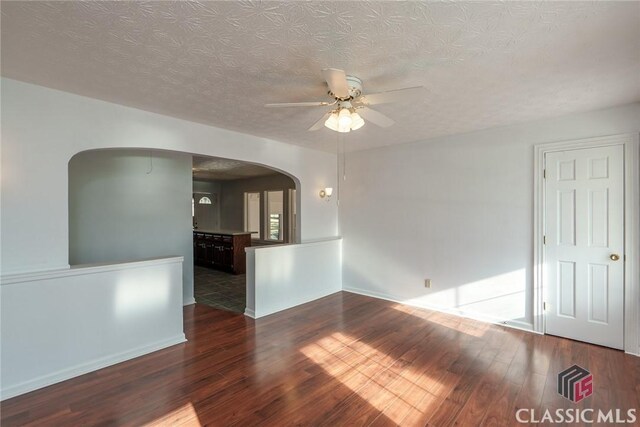1050 Eugene Ln, Madison, GA 30650 - empty room with arched walkways, a textured ceiling, wood finished floors, and a ceiling fan