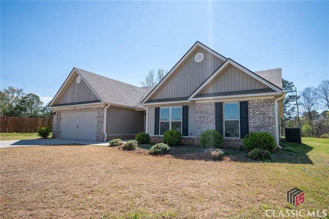 craftsman-style home featuring fence, board and batten siding, an attached garage, a front lawn, and brick siding