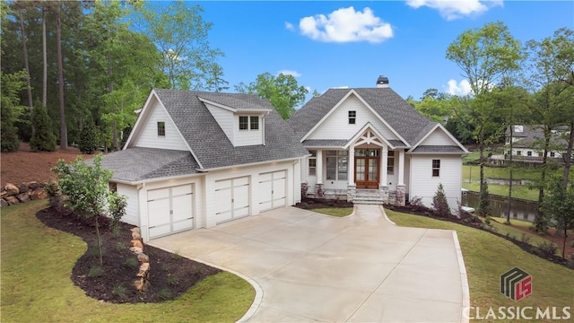 neoclassical / greek revival house with a front yard, a shingled roof, a chimney, concrete driveway, and an attached garage