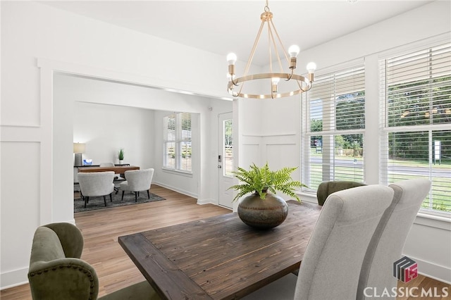 dining room with a chandelier and wood finished floors