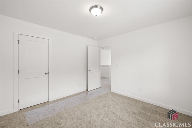 unfurnished bedroom with baseboards and carpet