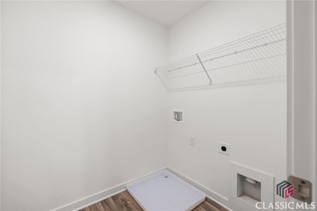 laundry area featuring baseboards, washer hookup, wood finished floors, laundry area, and electric dryer hookup