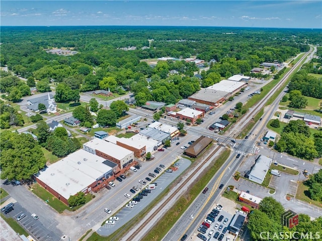 drone / aerial view with a wooded view
