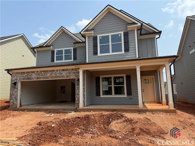 333 Ridge Pointe Dr, Athens, GA 30606 - view of front of home with covered porch, an attached garage, driveway, and board and batten siding