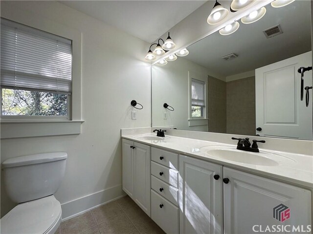 full bathroom featuring baseboards, toilet, tile patterned flooring, and a sink