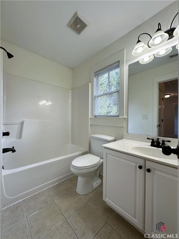 full bathroom with visible vents, toilet, vanity, shower / washtub combination, and tile patterned flooring