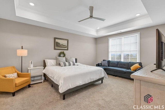 bedroom featuring a raised ceiling, light carpet, crown molding, and recessed lighting