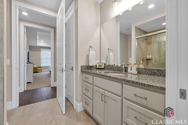 full bathroom with tile patterned floors, vanity, a shower stall, baseboards, and recessed lighting