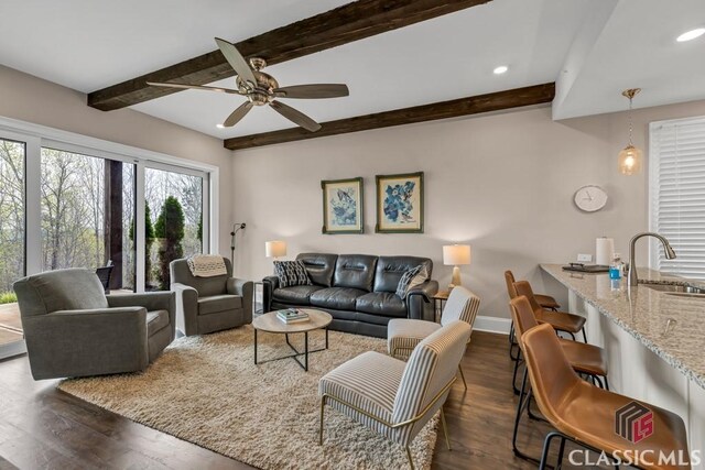 living area with beam ceiling, a ceiling fan, dark wood finished floors, baseboards, and recessed lighting