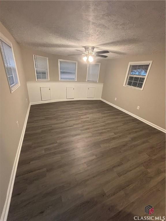 626 Vine St, Athens, GA 30601 - unfurnished room with dark wood-type flooring, ceiling fan, and a textured ceiling