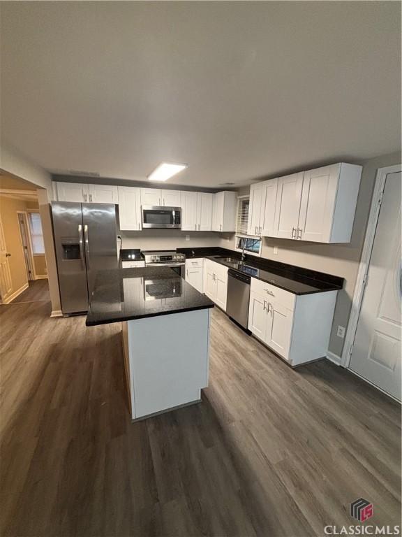 626 Vine St, Athens, GA 30601 - kitchen featuring white cabinets, appliances with stainless steel finishes, and dark wood-style floors