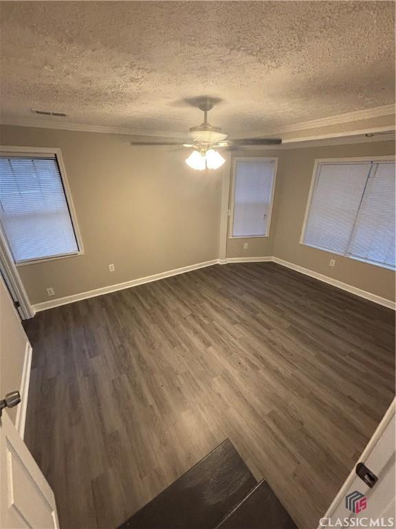 626 Vine St, Athens, GA 30601 - unfurnished room with ornamental molding, a textured ceiling, a ceiling fan, and dark wood-style floors