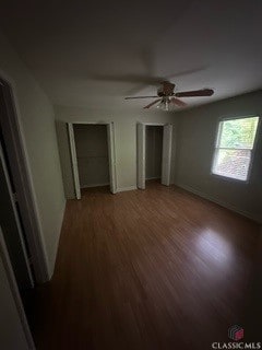 625 Whitehall Rd, Athens, GA 30605 - unfurnished bedroom with light wood finished floors, a ceiling fan, baseboards, and two closets