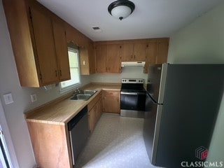 625 Whitehall Rd, Athens, GA 30605 - kitchen featuring appliances with stainless steel finishes, extractor fan, light countertops, a sink, and brown cabinetry